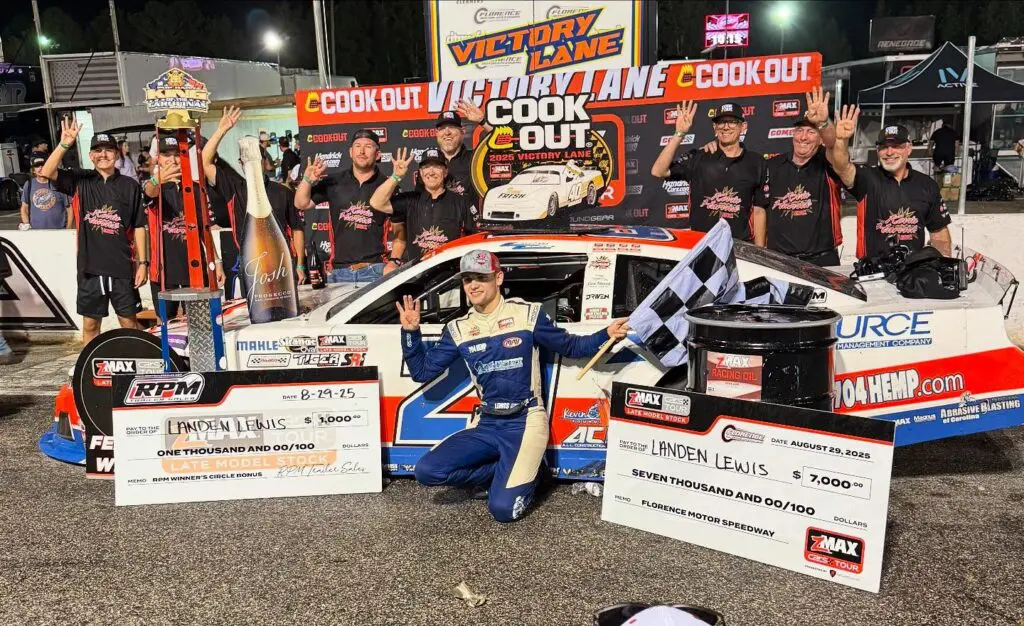 Driver holds checkered flag in victory lane