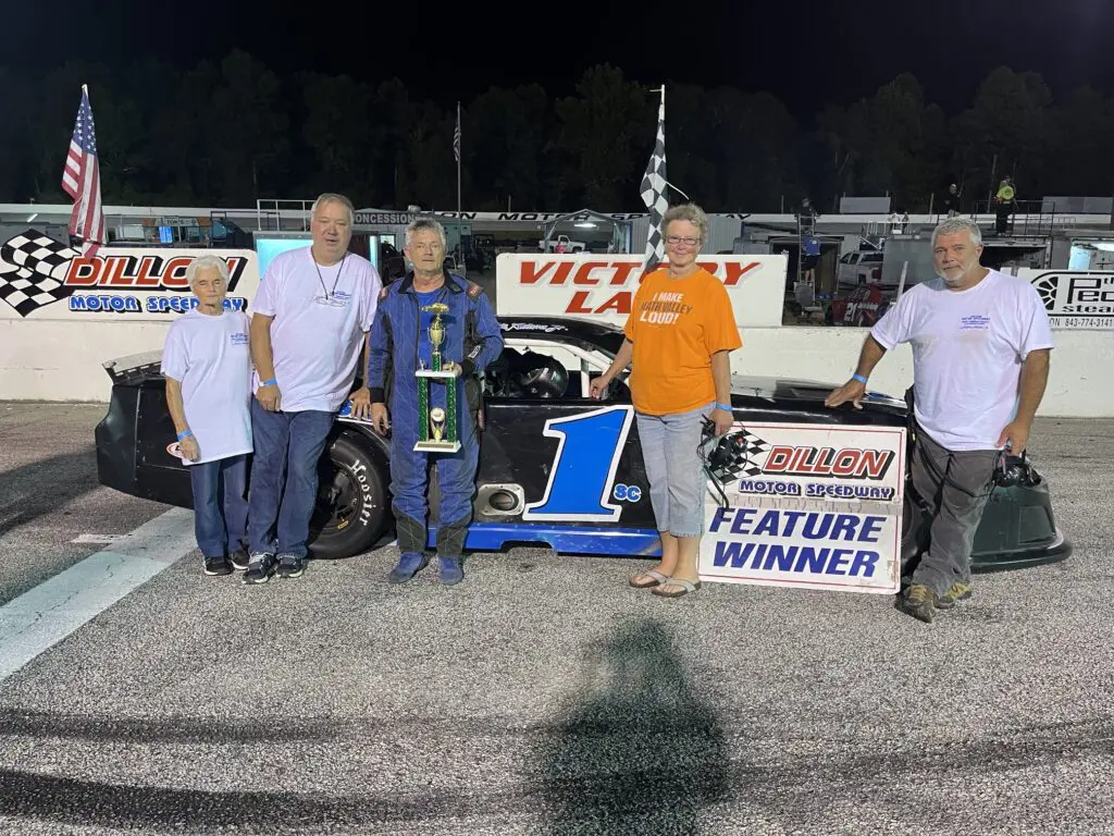 Group celebrates race car victory at night