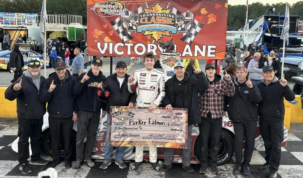 Team celebrates win at motorsport event.