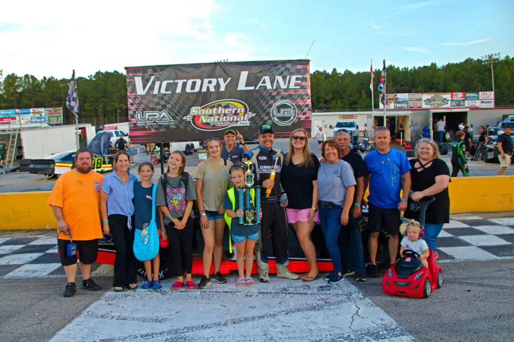 Group celebrating in Victory Lane