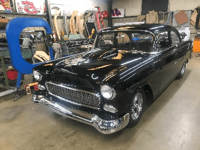 A black car is parked in the garage.