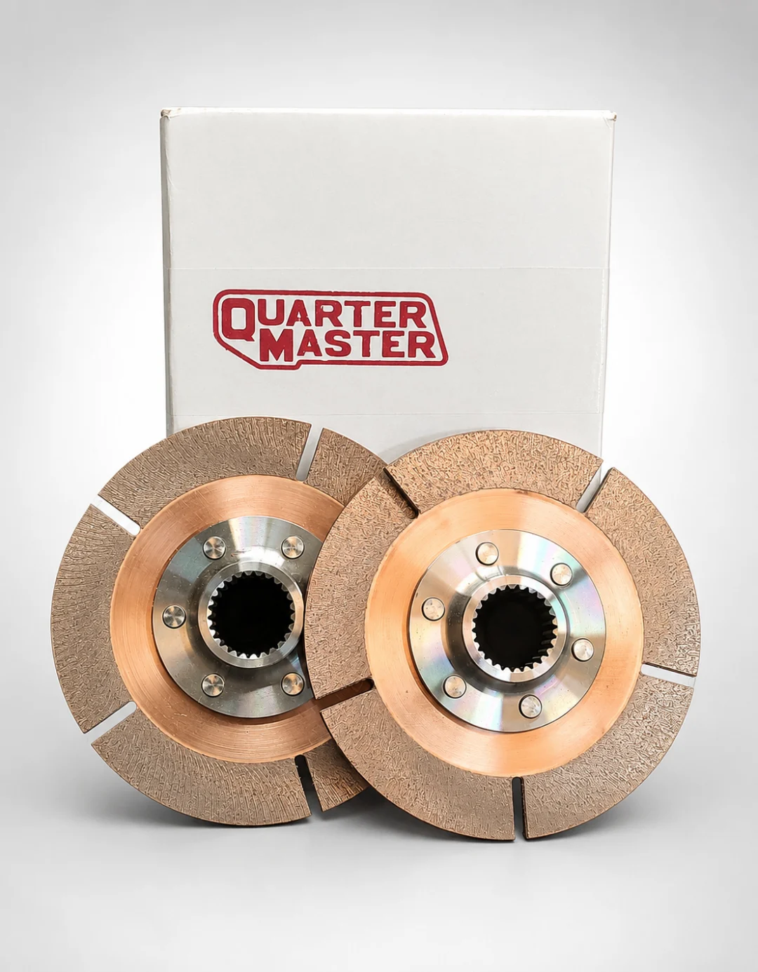 White box with a pair of clutch discs inside, sitting on a white surface