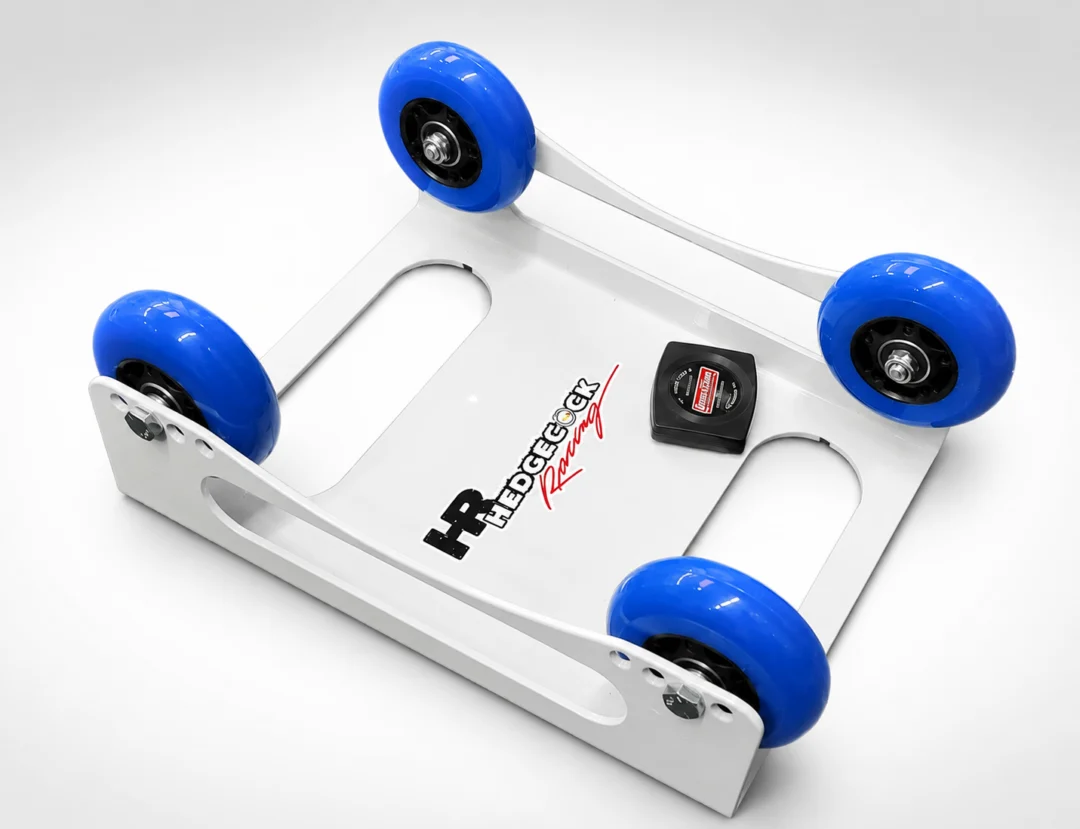 White and blue hedgecock racing chassis with four blue wheels on a white background